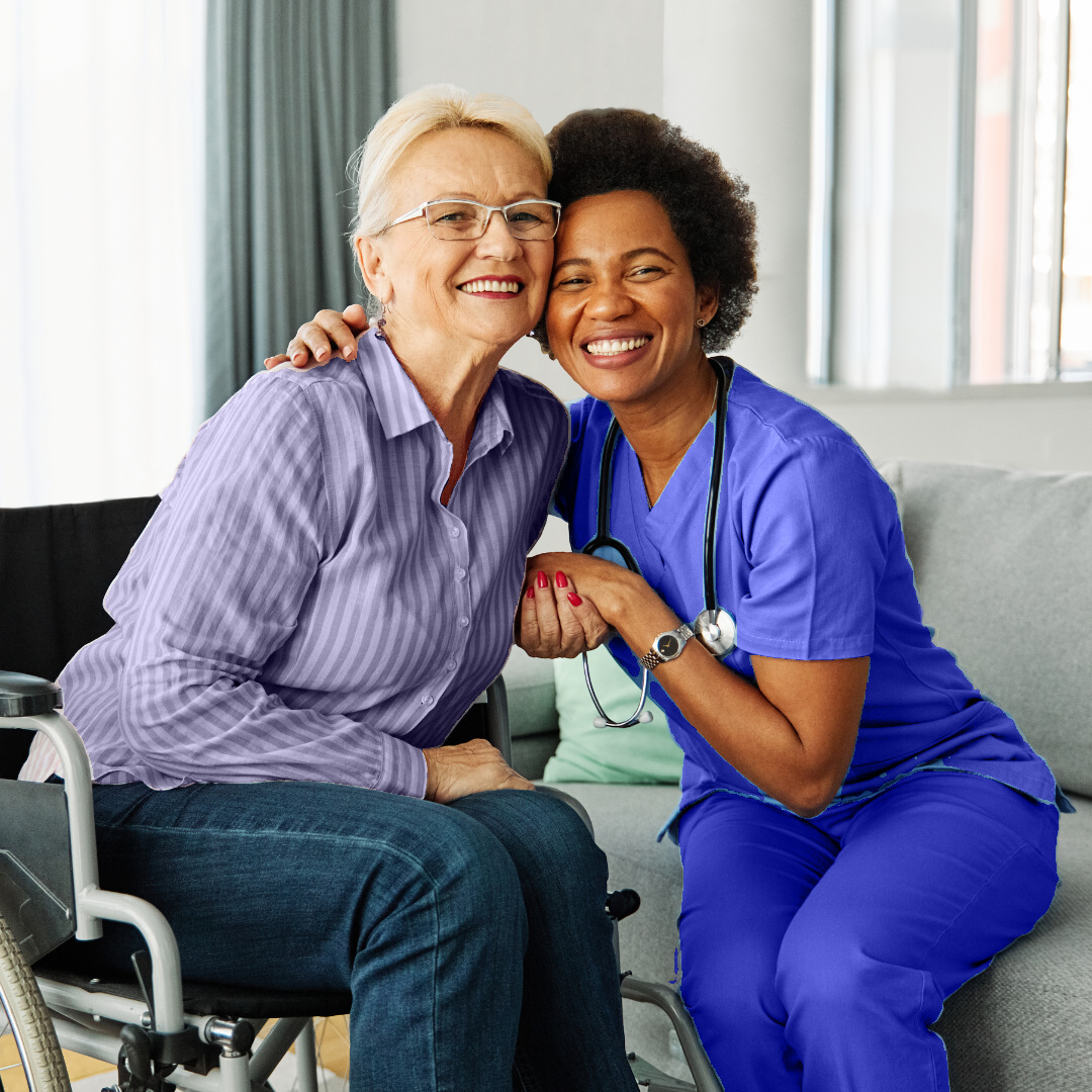 caregiver and a senior woman hugging and smiling with each other